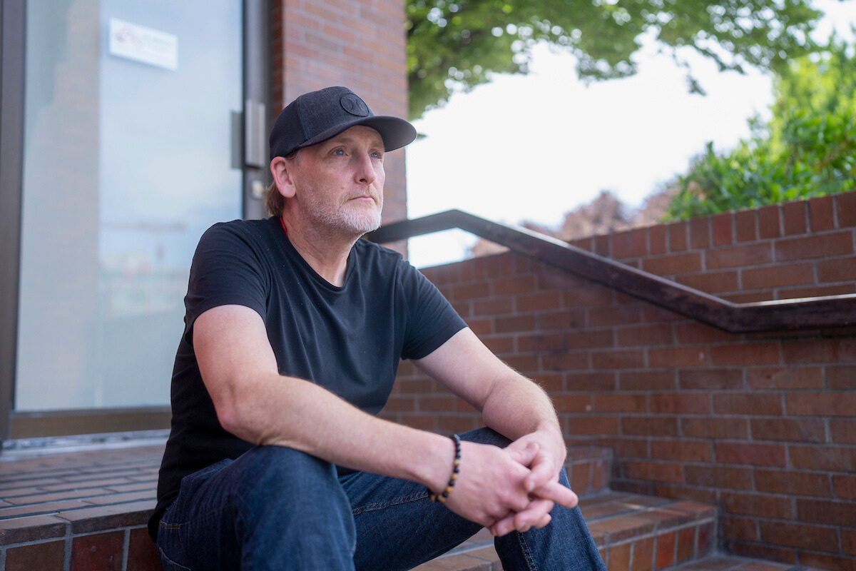 A client sitting on stair steps