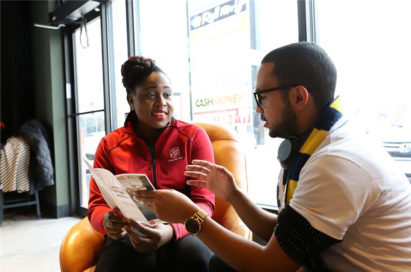 A staff member explaining the offered programs to a client